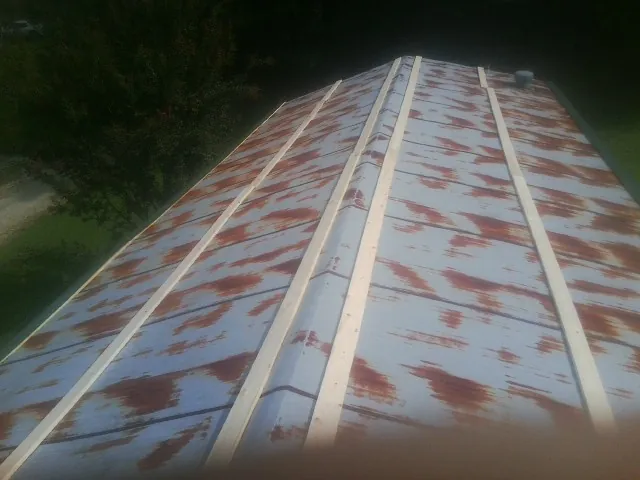 Rusted metal roof panels with new wood purlins before replacement — Storm Damage Roof Repair in Steubenville by Roofing Brothers