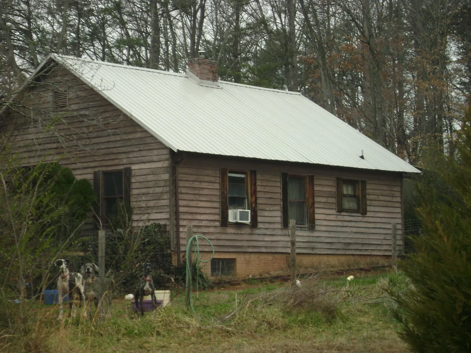 White metal roof on an old wood sided farmhouse, from a Metal Roof Installation job in Steubenville